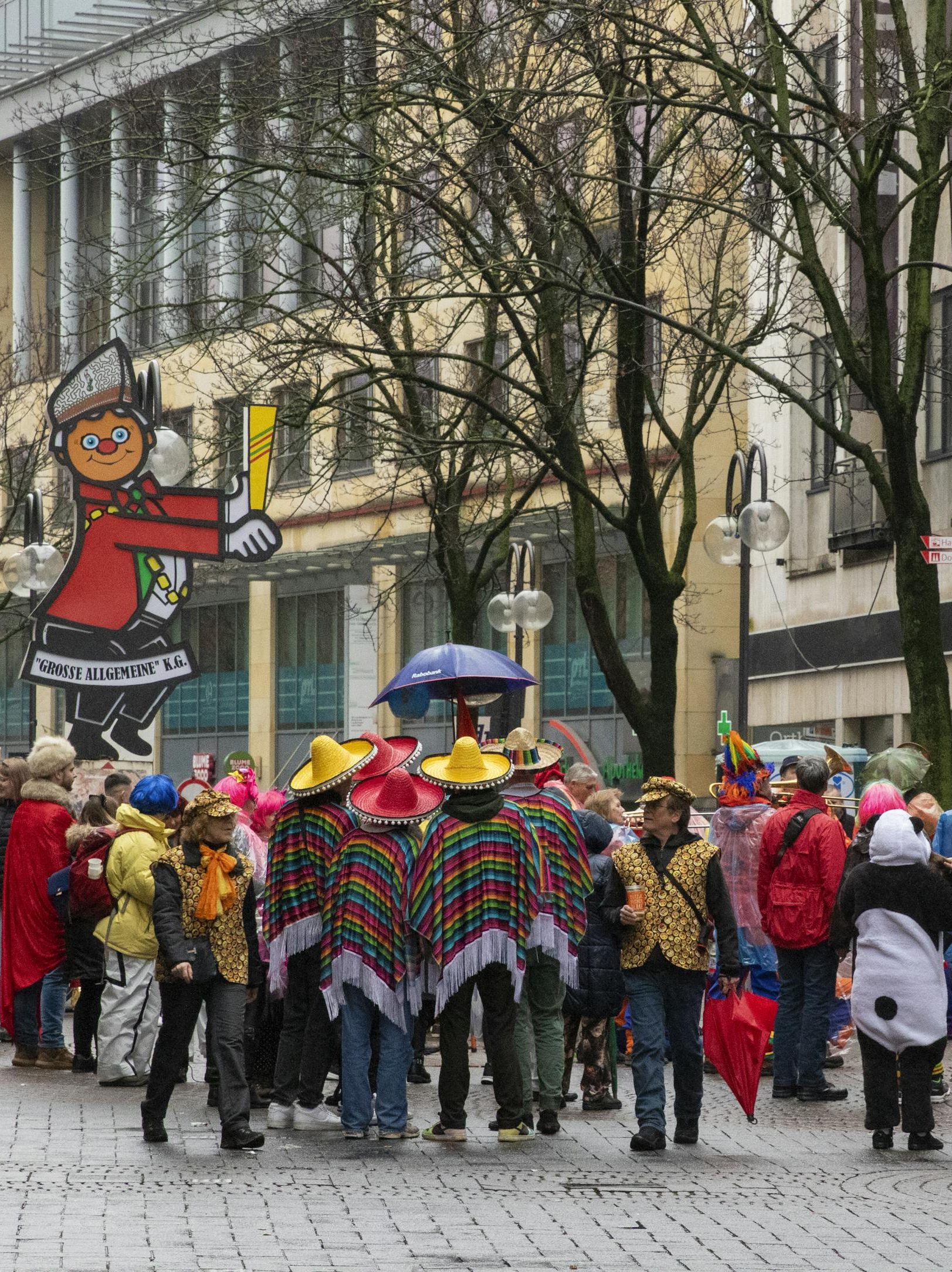 Vibrant street celebration during Cologne's famous carnival festival with attendees in colorful costumes and parade floats.